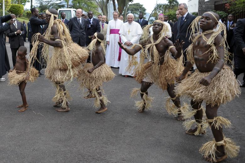 A group of Pygmies from Cameroon's Baka tribe perform for Pope Benedict XVI as he leaves the Vatican embassy on his way to the Angola, in Yaounde, Cameroon,  Friday, March 20, 2009. Pope Benedict XVI is in Africa for a seven-day visit that will take him to Cameroon and Angola.