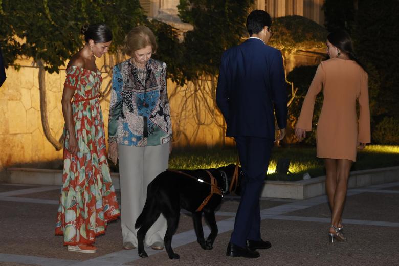 La Reina Letizia y la Reina Sofía saludan a uno de los invitados a la recepción en Marivent que ha acudido acompañado de su perro lazarillo
