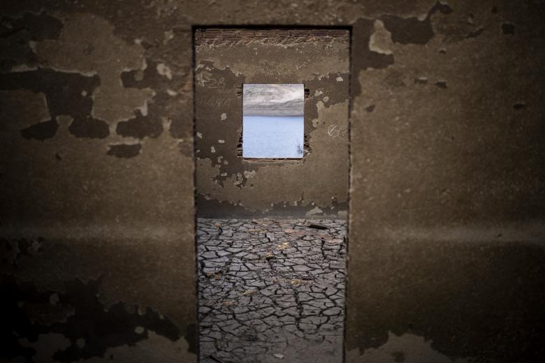 FILE, A  view of a house in the old village of Aceredo, once submerged three decades ago when a hydropower dam flooded the valley which reemerged due to drought, at the Lindoso reservoir, in northwestern Spain, Friday, Feb. 11, 2022.