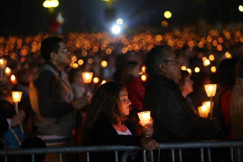 Faithfuls gather during a candle light vigil at the Our Lady of Fatima shrine, in Fatima, central Portugal, Tuesday, May 12, 2015.