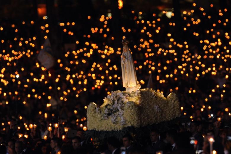 The statue of Our Lady of Fatima is carried through the crowd during a candle light vigil prayer at the Sanctuary of Our Lady of Fatima Friday, May 12 2017, in Fatima, Portugal.