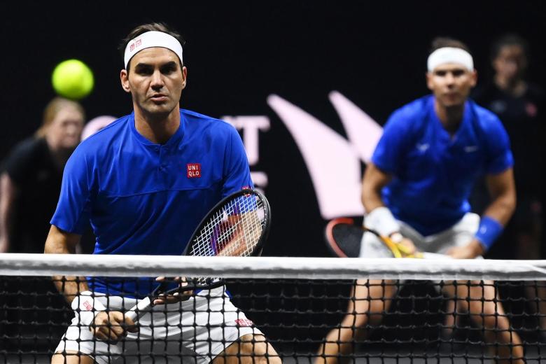 Federer, en primer plano, con Nadal detrás en un momento del encuentro de dobles