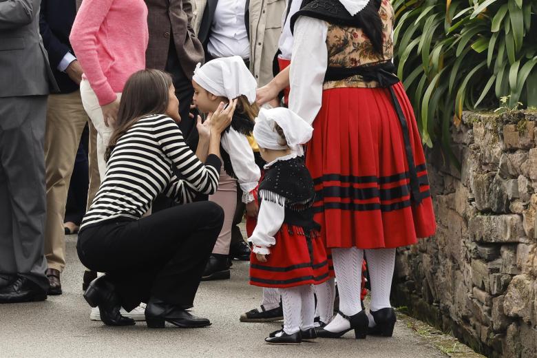 Una niña da un beso a la Reina Letizia durante la visita Real a Cadavedo