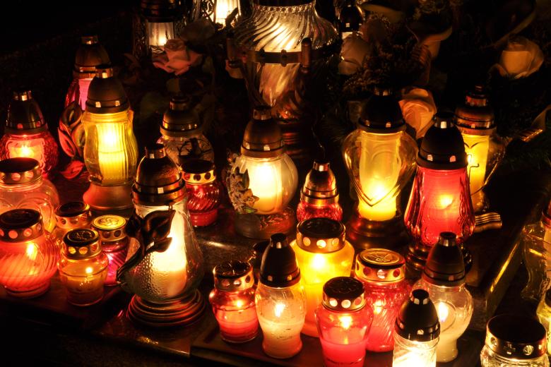 Candle flames illuminating on Polish cemetery during the night of All Saint's Day