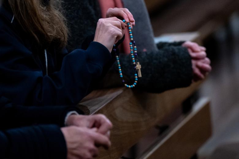 A woman holds a rosary in her hands at St. Oswald Church during a service for Pope Emeritus Benedict XVI. Pope Emeritus Benedict XVI died Dec. 31, 2022, at the Vatican at the age of 95. 
celebrity church Pope pray prayer religion Religion and Belief ReligiÃ³n Vatican