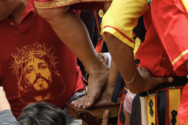 Paombong (Philippines), 07/04/2023.- Filipino penitent Precy Valencia is nailed to a wooden cross as Catholic devotees mark Good Friday in Paombong municipality of Bulacan Province, north of Manila, Philippines 07 April 2023. Despite warnings from Catholic church and government health officials against self-inflicted pain during the Lent season, expressions of faith and penance in Bulacan province esi:included a depiction of the crucifixion of Jesus Christ. (Filipinas) EFE/EPA/ROLEX DELA PENA