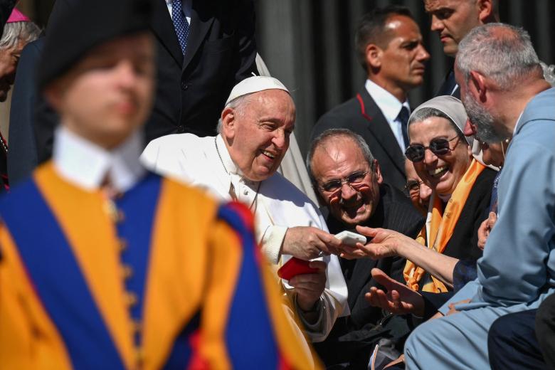 Pope Francis greets nuns at the end of his weekly general audience at Saint Peters' square in the Vatican, on April 26, 2023. (Photo by Vincenzo PINTO / AFP)