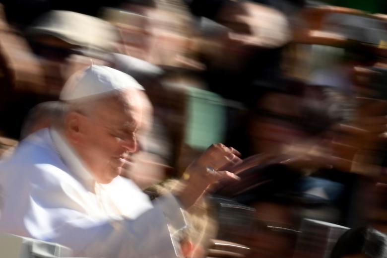 Pope Francis waves as he arrives on his pope mobile for the weekly general audience at Saint Peters' square in the Vatican, on April 26, 2023. (Photo by Vincenzo PINTO / AFP)