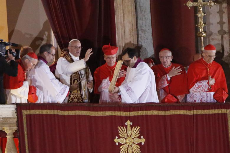 Pope Francis I greeting the crowd from the central balcony of St. Peter's Basilica moments after being elected, at the Vatican, Wednesday, March 13, 2013. Cardinal Jorge Bergoglio, who chose the name of Francis is the 266th pontiff of the Roman Catholic Church.