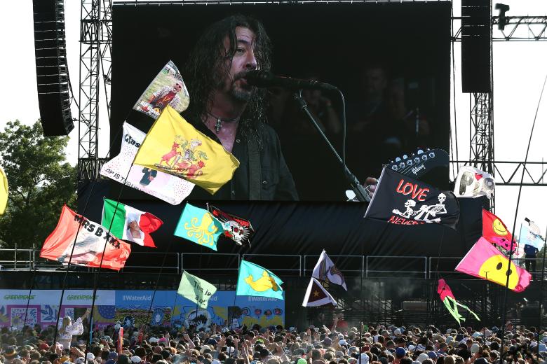 A screen shows the Foo Fighters performing as The Churnups on the Pyramid Stage at the Glastonbury Festival in Pilton, Britain, 23 June 2023.