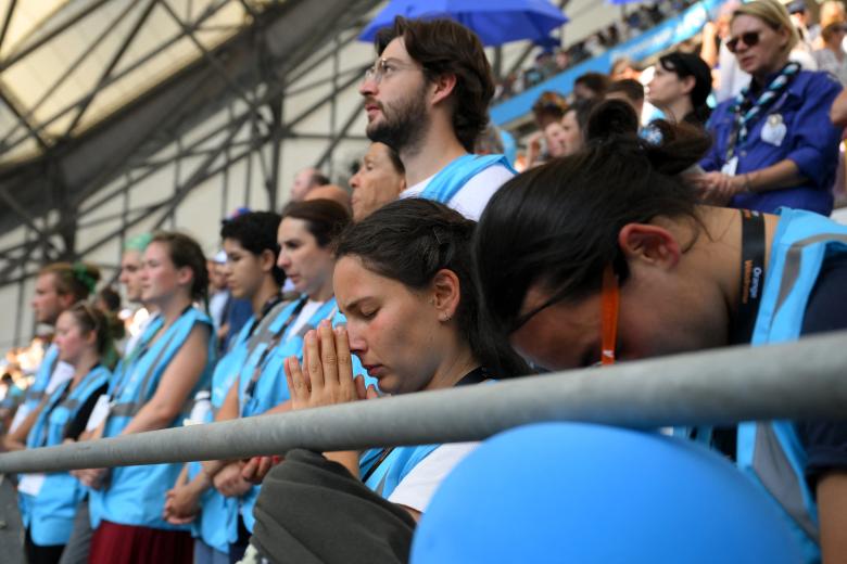 Los fieles rezan mientras el Papa celebra la misa en el estadio Velódromo