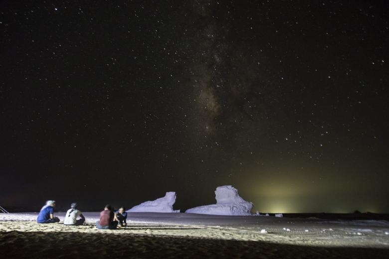 13 August 2021, Egypt, Farafra: A Picture taken on 13 August shows a group of people watching the Perseid meteor shower in the White Desert north of the Farafra Oasis in the New Valley Governorate.