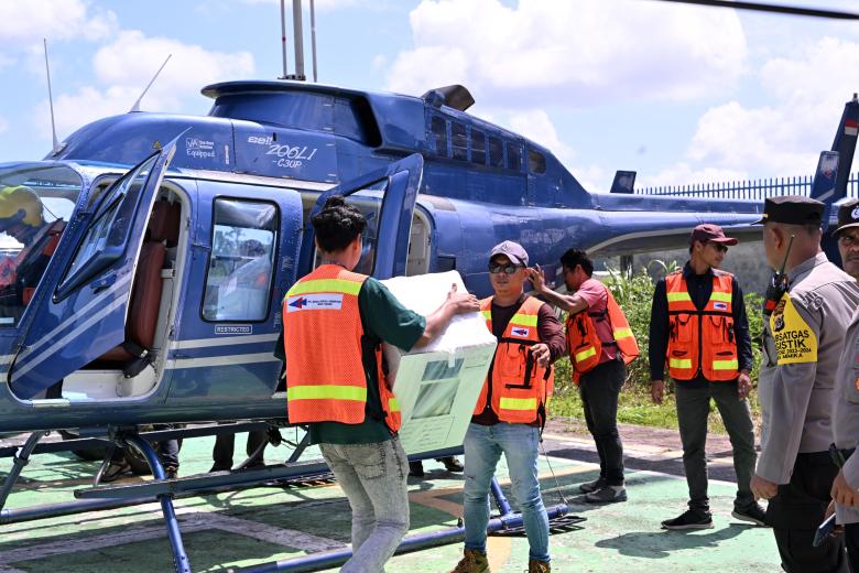 Workers load elections materials into a helicopter during a distribution in Timika, Central Papua on February 12, 2024, ahead of the general elections. (Photo by ADEK BERRY / AFP)