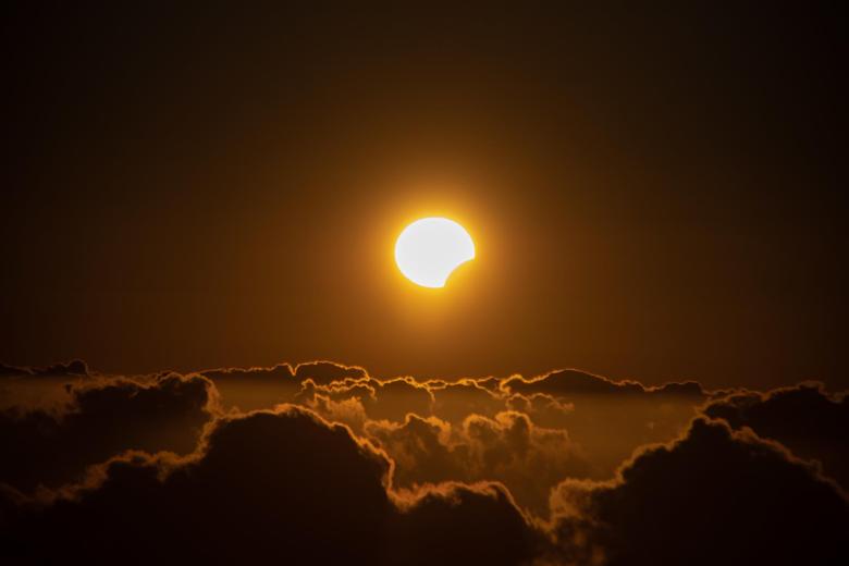 Las islas más occidentales de Canarias han sido uno de los pocos puntos de España desde donde se ha visto el eclipse solar de este 8 de abril, aunque de forma parcial. En la imagen, el eclipse sobre el mar de nubes, fotografiado desde Garafía, en las cumbres de La Palma.