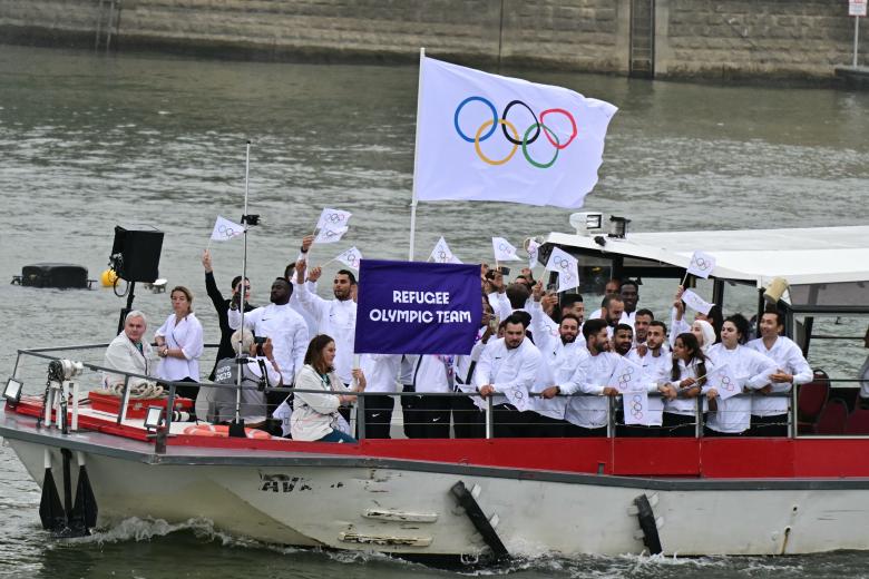 Athletes from Greece's delegation sail in a boat along the river Seine near Notre Dame de Paris cathedral during the opening ceremony of the Paris 2024 Olympic Games in Paris on July 26, 2024. (Photo by Jack GUEZ / AFP)