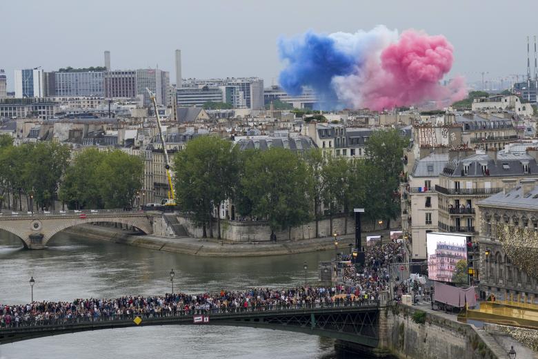 Fireworks in the French national colours explode over Pont d'Austerlitz during the opening ceremony of the Paris 2024 Olympic Games in Paris on July 26, 2024. (Photo by Miguel MEDINA / AFP)