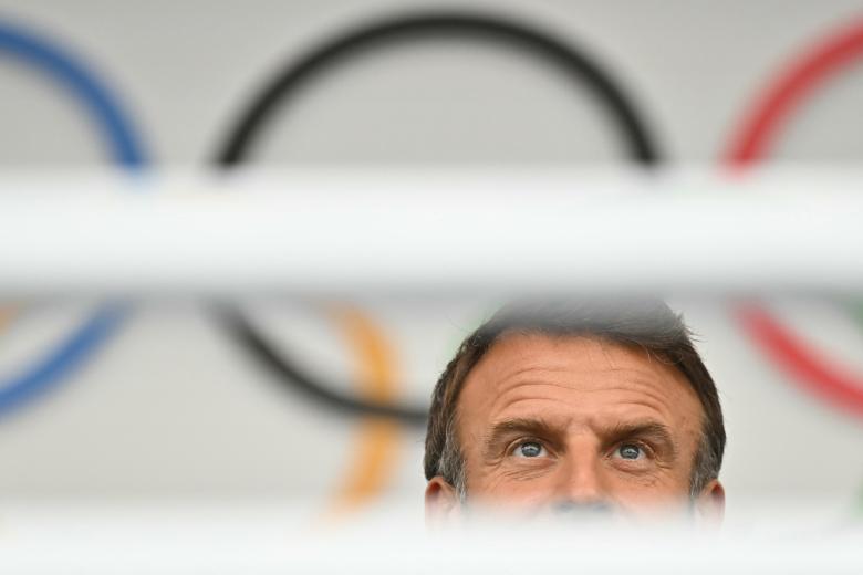 French President Emmanuel Macron looks on during the opening ceremony of the Paris 2024 Olympic Games in Paris on July 26, 2024. (Photo by Fabrice COFFRINI / AFP)