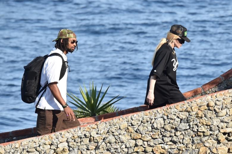 BGUK_2998405 - Portofino, ITALY  - The Legendary American Singer/Songwriter Madonna spotted out in the Italian sunshine arriving at Dolce and Gabbana's Portofino Villa with her new mystery man.

The 65-year old showed off her cool side, wearing her New York Yankee top, sunglasses and cap as she arrived in style via a boat as the 'Queen of Pop' was helped ashore by her entourage as she spends her holidays at the designers pad with her mystery beau.

Pictured: Madonna

BACKGRID UK 11 AUGUST 2024 

BYLINE MUST READ: COBRA TEAM / BACKGRID

UK: +44 208 344 2007 / uksales@backgrid.com

USA: +1 310 798 9111 / usasales@backgrid.com

*Pictures Containing Children Please Pixelate Face Prior To Publication* *** Local Caption *** .