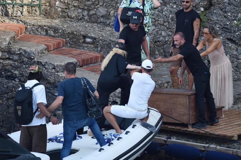 BGUK_2998405 - Portofino, ITALY  - The Legendary American Singer/Songwriter Madonna spotted out in the Italian sunshine arriving at Dolce and Gabbana's Portofino Villa with her new mystery man.

The 65-year old showed off her cool side, wearing her New York Yankee top, sunglasses and cap as she arrived in style via a boat as the 'Queen of Pop' was helped ashore by her entourage as she spends her holidays at the designers pad with her mystery beau.

Pictured: Madonna

BACKGRID UK 11 AUGUST 2024 

BYLINE MUST READ: COBRA TEAM / BACKGRID

UK: +44 208 344 2007 / uksales@backgrid.com

USA: +1 310 798 9111 / usasales@backgrid.com

*Pictures Containing Children Please Pixelate Face Prior To Publication* *** Local Caption *** .