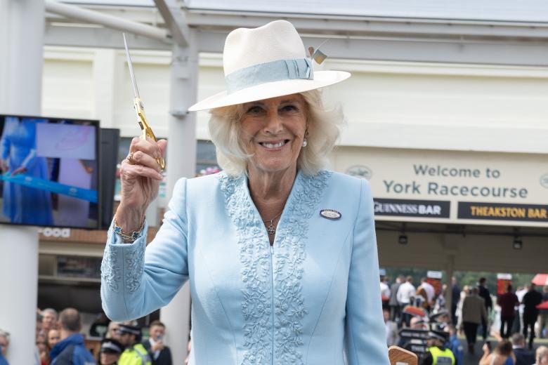 Queen Camilla watches the Falcons Display Team during a visit to open the Bustardthorpe Development at York Racecourse, which has been designed to improve the experience for racegoers and has sustainability at its heart, with rainwater harvest tanks, solar panels and a living roof during day four of the Sky Bet Ebor Festival at York Racecourse. Picture date: Saturday August 24, 2024. *** Local Caption *** .