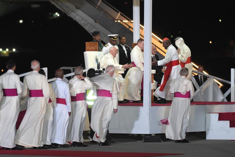 Members of the clergy greet Pope Francis upon his arrival at Port Moresby International airport on September 6, 2024. Pope Francis landed in Papua New Guinea's Port Moresby on September 6, the second stop of a marathon 12-day tour to the Asia-Pacific region. (Photo by Andrew KUTAN / AFP)