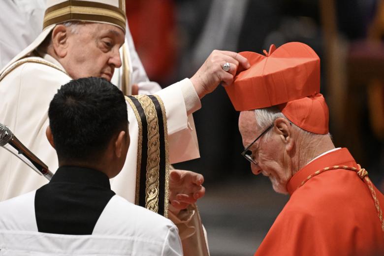 Pope Francis places the biretta upon the head of newly-appointed Argentina cardinal Vicente Bokalic Iglic during an Ordinary Public Consistory for the creation of new cardinals, at St Peter's Basilica in the Vatican, on December 7, 2024. On December 7, Pope Francis will create 21 new cardinals from five continents, including bishops from Algiers, Tehran, Tokyo and Abidjan, many of whom may one day help choose his successor. In the tenth such consistory since he became pope in 2013, Francis, 87, is seeking again to shape the upper echelons of the Catholic Church in his image, and consolidate his legacy as the leader of a more inclusive and global institution. (Photo by Tiziana FABI / AFP)