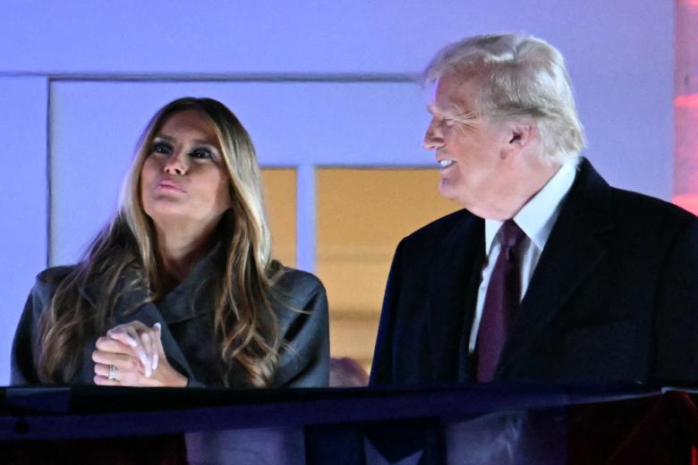 El presidente electo de EE.UU. Donald Trump y su esposa Melania Trump observan fuegos artificiales durante una recepción en su honor en el Trump National Golf Club Washington DC en Sterling, Virginia