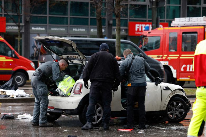 Members of the emergency services work at the scene where a car drove into a crowd in the southern German city of Munich on February 13, 2025 leaving several people injured, police said. Munich police said on social media platform X that "several people were injured" after "a car drove into a group of people" in the centre of the Bavarian state capital. (Photo by Michaela STACHE / AFP)