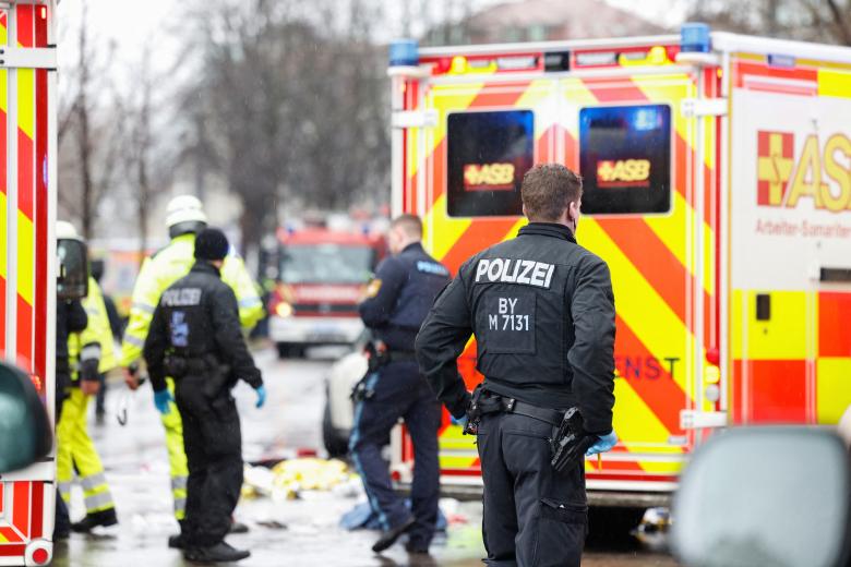 investigators search the car at the scene where a man drove into a crowd in the southern German city of Munich on February 13, 2025 leaving several people injured, police said. Munich police said on social media platform X that "several people were injured" after "a car drove into a group of people" in the centre of the Bavarian state capital. (Photo by Michaela STACHE / AFP)
