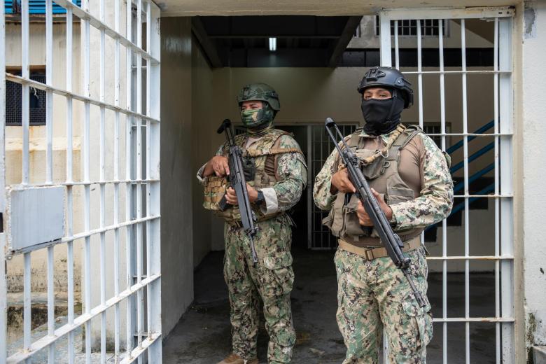 Military personnel guards inmates during a tour to check the reinforcement of security in the wards in order to prevent riots, at the Penitenciaria del Litoral in Guayaquil, Ecuador, on April 9, 2025. (Photo by MARCOS PIN / AFP)