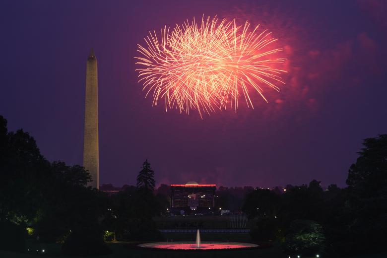 US President Donald Trump and First Lady Melania Trump watch fireworks after the Army 250th Anniversary Parade in Washington, DC on June 14, 2025. US President Donald Trump reveled in a long dreamt-of military parade on his 79th birthday Saturday, as demonstrators across the country branded him a dictator in the biggest protests since his return to power. (Photo by Doug MILLS / POOL / AFP)