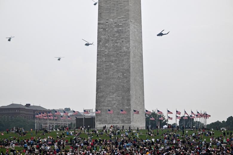 The Washington monument is seen in the distance as armored vehicles participate in the Army 250th Anniversary Parade in Washington, DC, on June 14, 2025. US President Donald Trump reveled in a long dreamt-of military parade on his 79th birthday Saturday, as demonstrators across the country branded him a dictator in the biggest protests since his return to power. (Photo by Alex WROBLEWSKI / AFP)