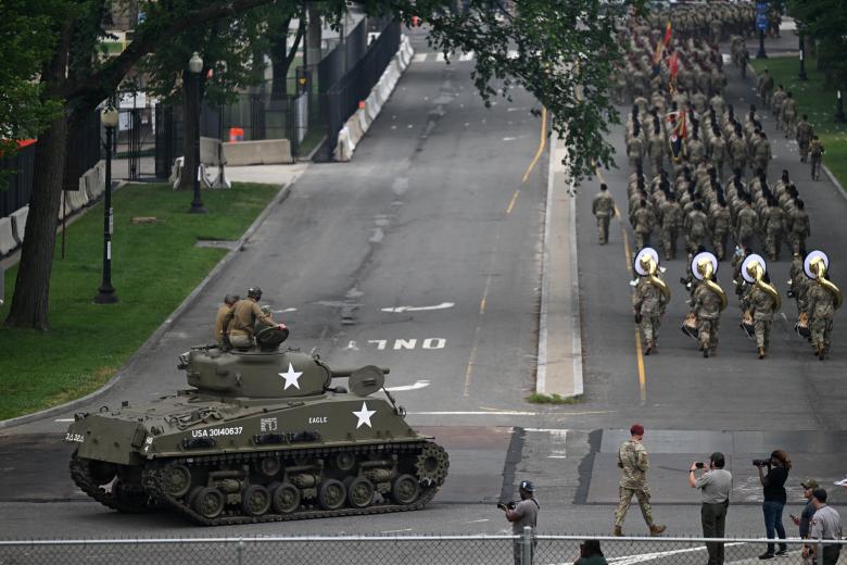 US military service members from the Army Drill Team march during the Army 250th Anniversary Parade in Washington, DC on June 14, 2025. Trump's long-held dream of a parade will come true as nearly 7,000 troops plus dozens of tanks and helicopters rumble through the capital in an event officially marking the 250th anniversary of the US army. (Photo by Mandel NGAN / AFP)