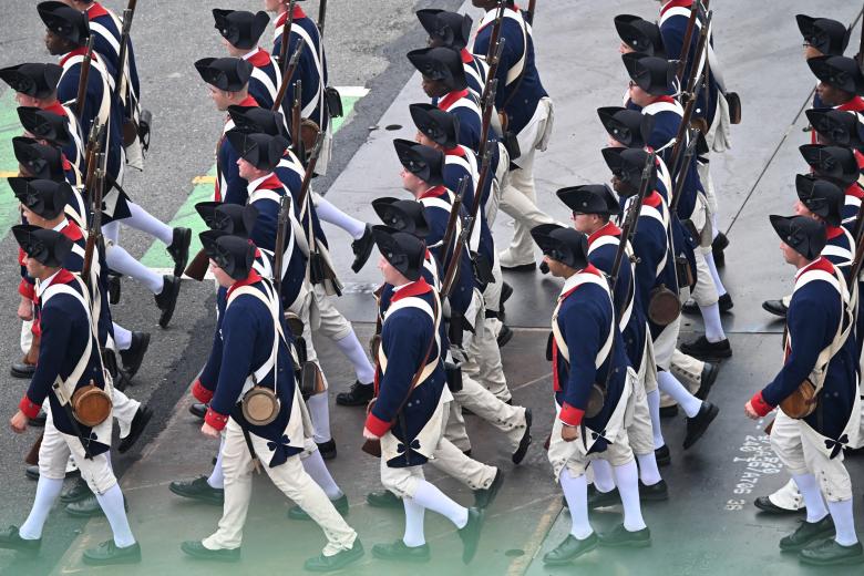 Soldiers wearing period uniforms from the Revolutionary war march during the Army 250th Anniversary Parade in Washington, DC on June 14, 2025. Trump's long-held dream of a parade will come true as nearly 7,000 troops plus dozens of tanks and helicopters rumble through the capital in an event officially marking the 250th anniversary of the US army. (Photo by Alex WROBLEWSKI / AFP)