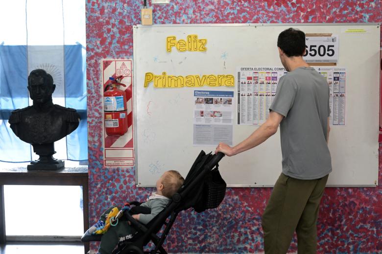 Argentina's President Javier Milei waves to supporters as he leaves after voting during the national midterm legislative election in Buenos Aires on October 26, 2025. Argentines head to the polls for a midterm election that will determine whether President Javier Milei enters the second half of his term bolstered or diminished as economic troubles abound despite unprecedented US aid. (Photo by Luis ROBAYO / AFP)