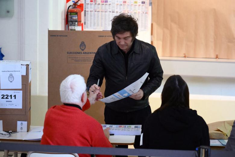 A woman cast her vote at a polling station during the national midterm legislative election in Buenos Aires on October 26, 2025. Argentines head to the polls for a midterm election that will determine whether President Javier Milei enters the second half of his term bolstered or diminished as economic troubles abound despite unprecedented US aid. (Photo by JUAN MABROMATA / AFP)