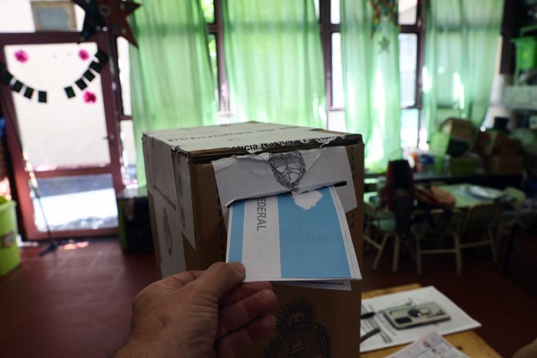 Argentina's President Javier Milei votes at a polling station during the national midterm legislative elections in Buenos Aires on October 26, 2025. Argentines head to the polls for a midterm election that will determine whether President Javier Milei enters the second half of his term bolstered or diminished as economic troubles abound despite unprecedented US aid. (Photo by Luis ROBAYO / AFP)