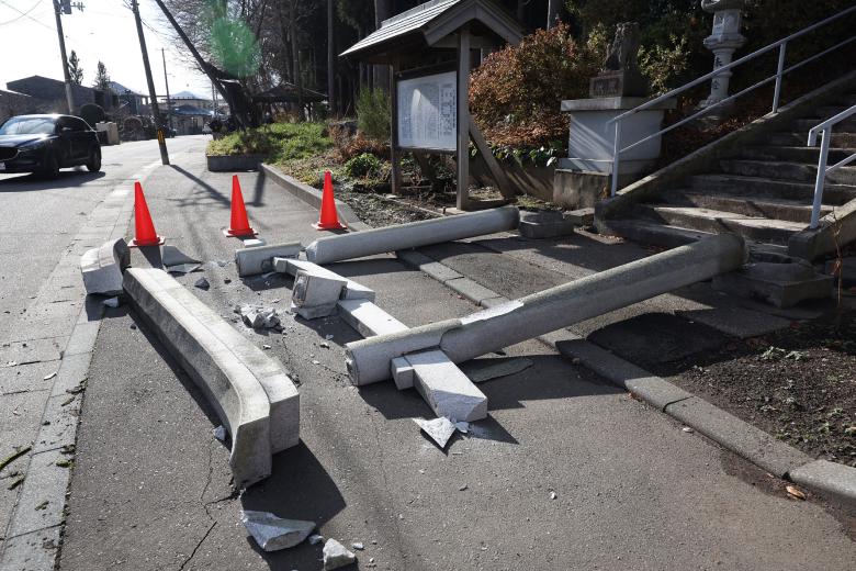 A torii gate at the entrance of Yasaka Shrine is seen after it collapsed onto a sidewalk in Hachinohe City in Aomori Prefecture on December 9, 2025, following a 7.5 magnitude earthquake off northern Japan. A big quake off northern Japan left at least 30 injured, authorities said on December 9, damaging roads and leaving thousands without power in freezing temperatures. (Photo by JIJI Press / AFP) / Japan OUT / JAPAN OUT / JAPAN OUT