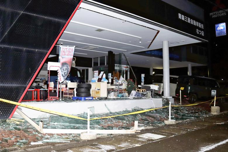 Windows are broken by massive earthquake at a car dealership in Mutsu City, Aomori Prefecture on December 9, 2025. The magnitude 7.5 earthquake struck off the northeastern coast of Aomori Prefecture at 11:15 p.m. on December 8th. The Tsunami warning has been issued for Aomori, Iwate and Hokkaido Prefectures, to announce evacuation on the same day. Although the Japan Meteorological Agency lifted its tsunami advisory at 6:20 a.m. on Dec. 9th, its official issues subsequent earthquake advisory and urge an alert for potentially larger ones.     ( The Yomiuri Shimbun ) (Photo by Shunsuke Ito / The Yomiuri Shimbun via AFP)