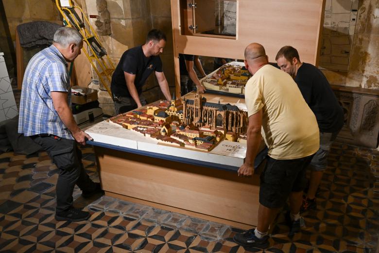 People install the cope of Charlemagne, a liturgical cope made of red silk woven with gold and silver, and the coronation cloak of Emperor Frederick II of Hohenstaufen, in the crypt of Saint-Etienne Cathedral in Metz, eastern France, on September 3, 2026. Leo XIV's stop in Metz on September 28 will mark the first papal visit to the city since Pope John Paul II in 1988, and will close out his four-day apostolic journey to France that also esi:includes Paris and Lourdes. (Photo by Jean-Christophe VERHAEGEN / AFP)