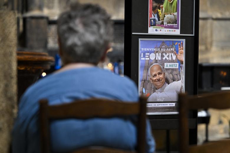 This photograph shows a banner hanging on a column inside the Saint-Etienne Cathedral the reading in French "So that the world may have life" and announcing the mass that Pope Leon XIV will celebrate on September 28, 2026, in Metz, eastern France, on September 3, 2026. (Photo by Jean-Christophe VERHAEGEN / AFP)