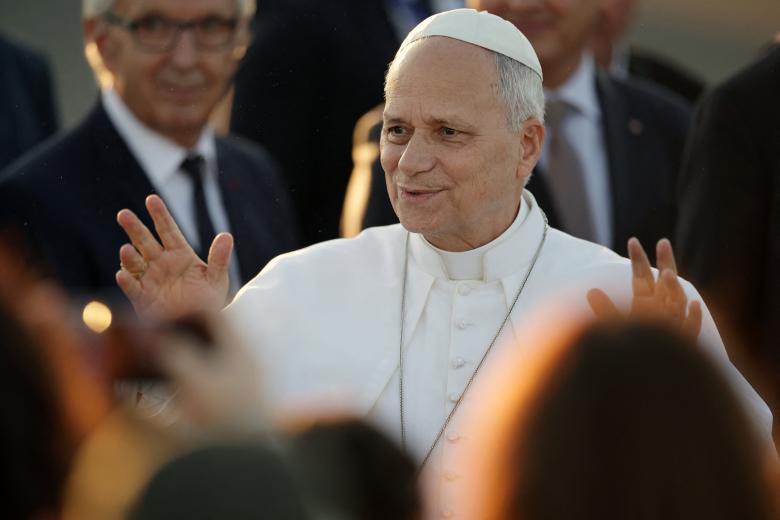 Pope Leo XIV reacts as he is welcomed upon landing at the Tarbes-Lourdes-Pyrenees International Airport, in Tarbes, southwestern France, on September 26, 2026 to travel to Lourdes, the second leg of his papal visit to France. (Photo by Valentine CHAPUIS / AFP)