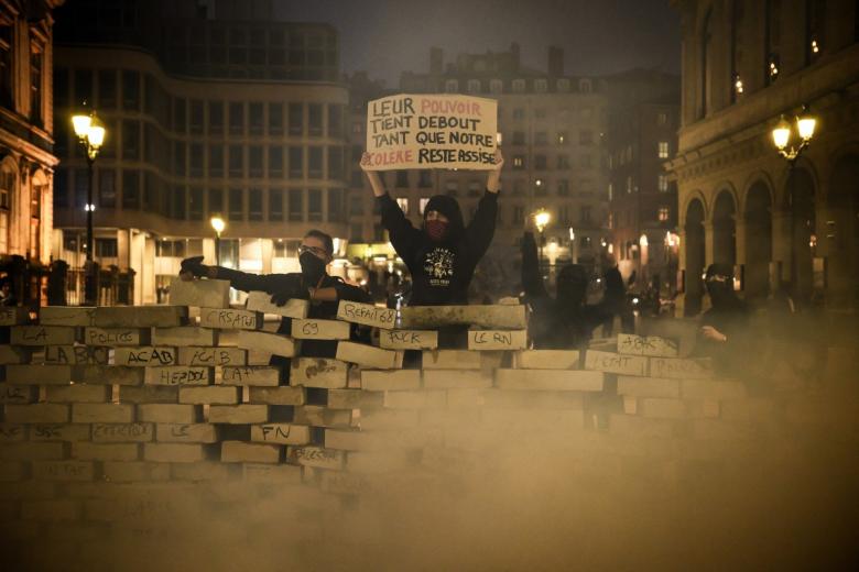 This photograph shows the Arc'Teryx shop ransacked and a fire in front during a demonstration to protest against the "high cost of living", in Paris on October 17, 2026 as part of a nationwide call for mobilisation bringing together various groups expressing their anger: former "Yellow Vests", secondary school and university students, climate activists and even farmers. After weeks of student protests, France faces broader, nationwide demonstrations on October 17, 2026 over the cost of living, setting up a potentially fraught six months heading into a presidential election. A police source told AFP that authorities estimated nearly 200,000 people could take part, with 40,000 in Paris. (Photo by Kiran RIDLEY / AFP)