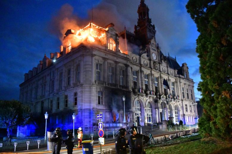 Demonstrators feed a fire with materials on Boulevard Haussmann during ongoing protest against the "high cost of living", in Paris on October 17, 2026 as part of a nationwide call for mobilisation bringing together various groups expressing their anger: former "Yellow Vests", secondary school and university students, climate activists and even farmers. After weeks of student protests, France faces broader, nationwide demonstrations on October 17, 2026 over the cost of living, setting up a potentially fraught six months heading into a presidential election. A police source told AFP that authorities estimated nearly 200,000 people could take part, with 40,000 in Paris. (Photo by Guillaume Saligot / AFP)