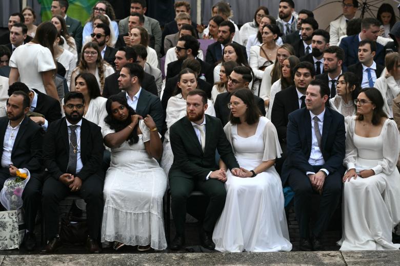 Catholic couples wearing their wedding outfits wait before the weekly general audience of Pope Leo XIV at St Peter's Square in The Vatican on October 21, 2026. (Photo by Tiziana FABI / AFP)
