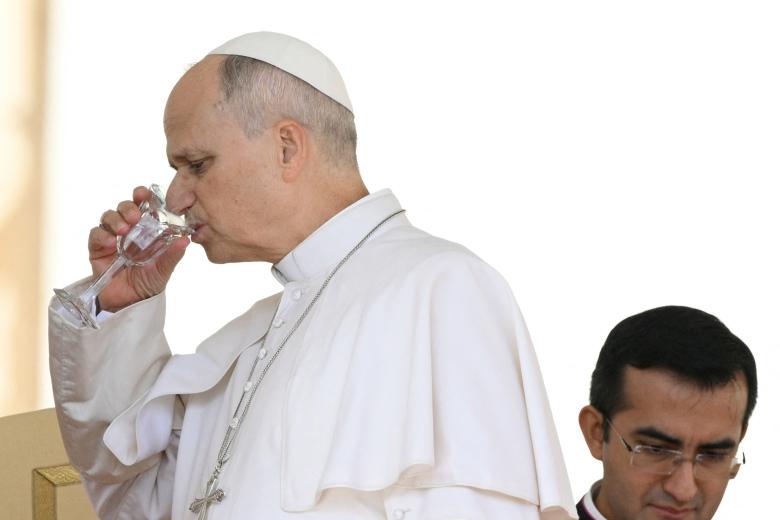 Pope Leo XIV drinks water during the weekly general audience at St Peter's Square in The Vatican on October 21, 2026. (Photo by Tiziana FABI / AFP)