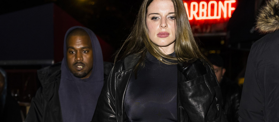 Kanye West and Julia Fox head out for a date night at celebrity hot spot, Carbone in New York City. The 31 year old 'Uncut Gems' actress wore a leather trench coat, crop top, low cut black trousers, and matching boots. West wore a blue hoodie, Balenciaga jacket, black jeans, and vintage Red Wing work safety boots.