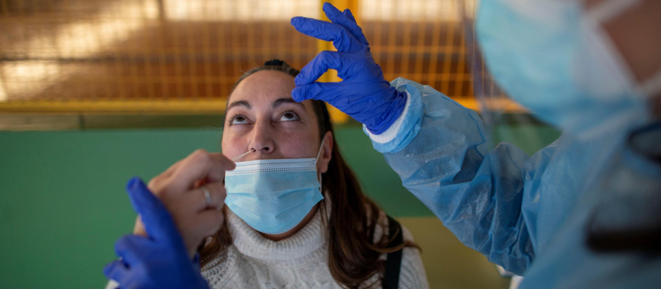 Un trabajador sanitario realiza un test de antígenos a una mujer durante el cribado poblacional celebrado en Ribadavia, en Ourense, este jueves