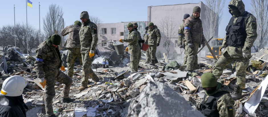 Soldados ucranianos buscan cuerpos entre los escombros de la escuela militar bombardeada por las tropas rusas, este sábado