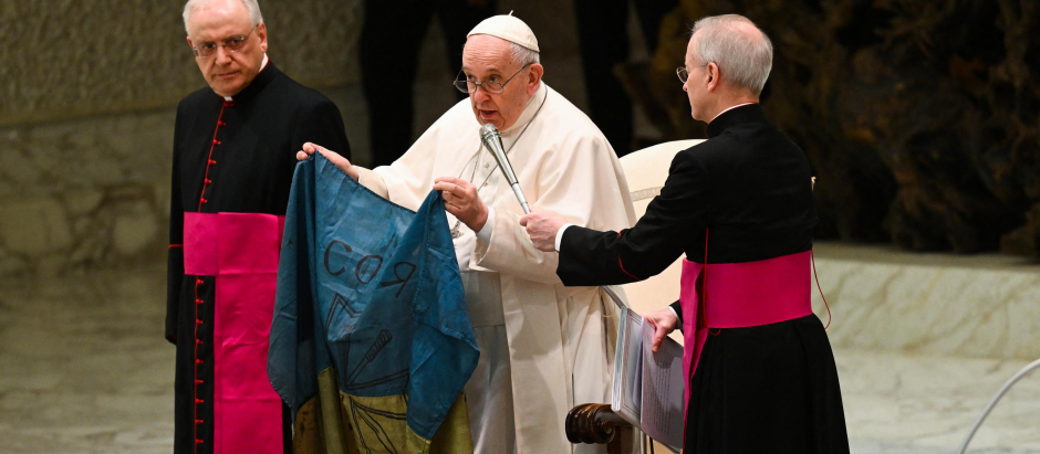 El Santo Padre sujeta una bandera de Ucrania traída de Bucha durante la audiencia general de este miércoles